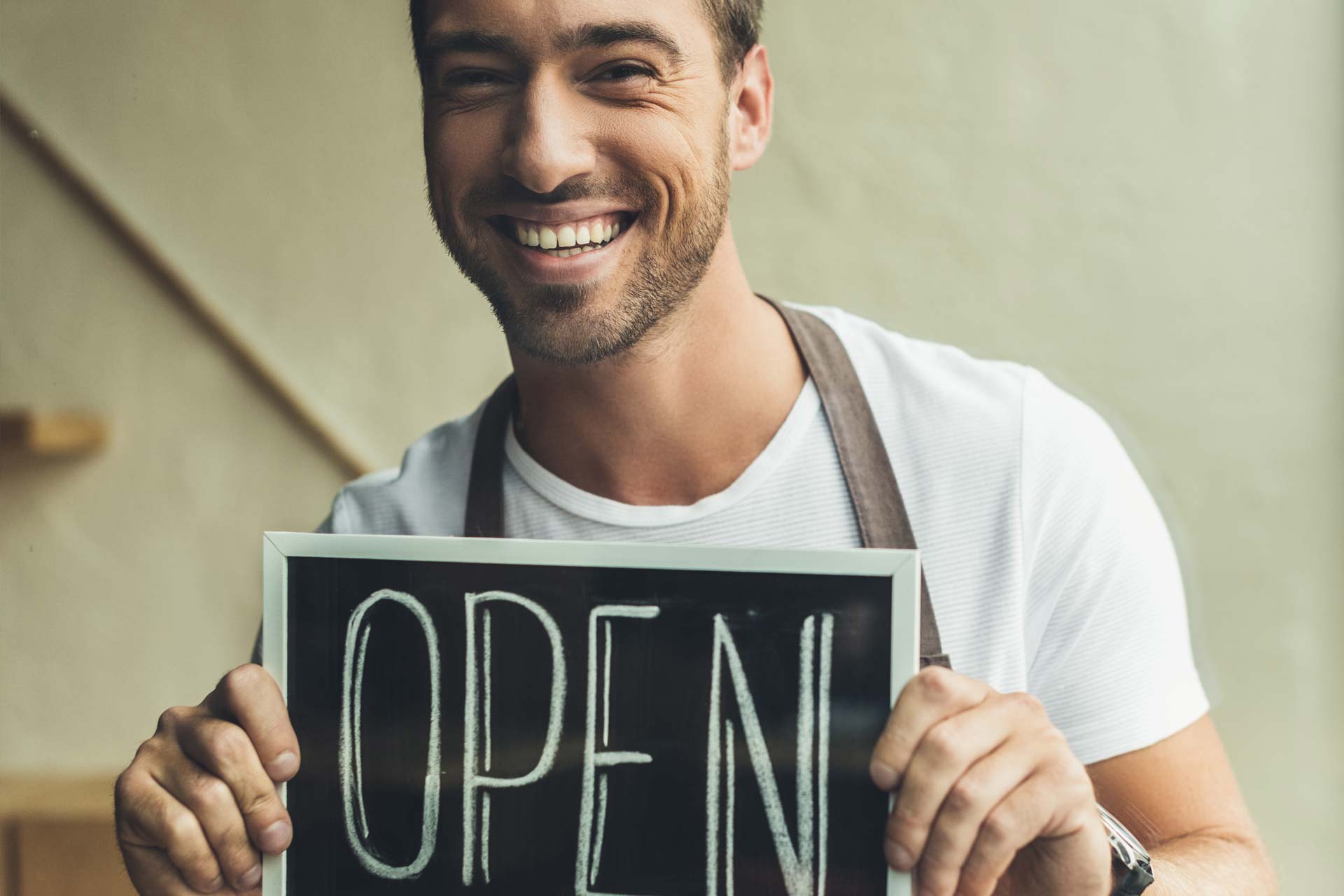 SEM company services for business image man smiling holding open sign | SEMDEEPDIVE | SEMDEEPDIVE SEM company services for business image man smiling holding open sign
